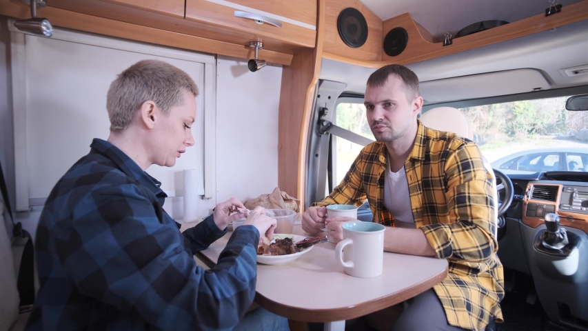 Family trip. Life in the motorhome. A way of life. RV. Camping. Discussion of problems sitting at the table. A joint dinner. Food. Dinner at the table. A nature trip. Trailer.