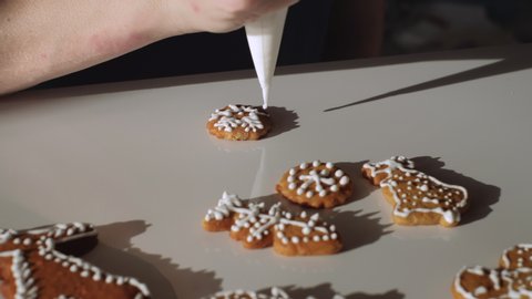 Traditional homemade gingerbread Christmas cookies being decorated and displayed. Dolly shot. Czech Republic
