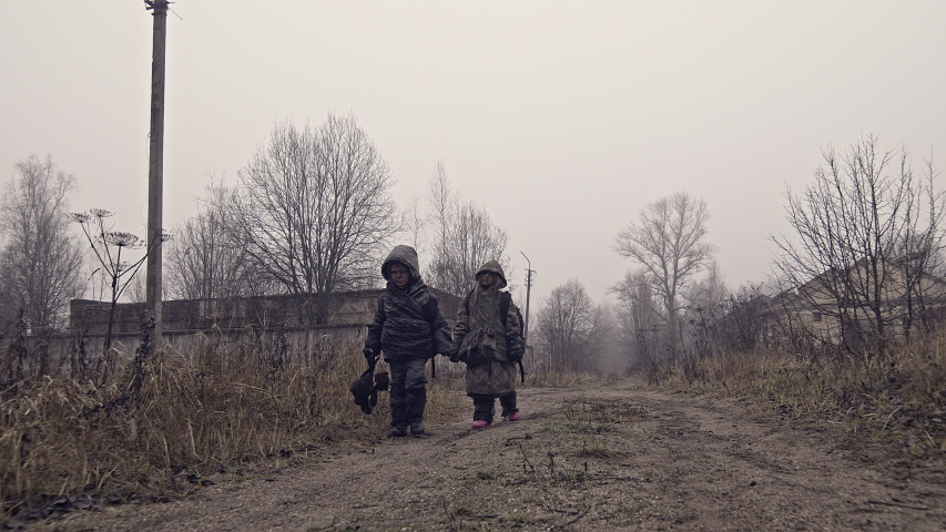Apocalypse. Homeless children go in search of life through the ruins of the city. War. Ecological catastrophy. | Shutterstock HD Video #1043358133