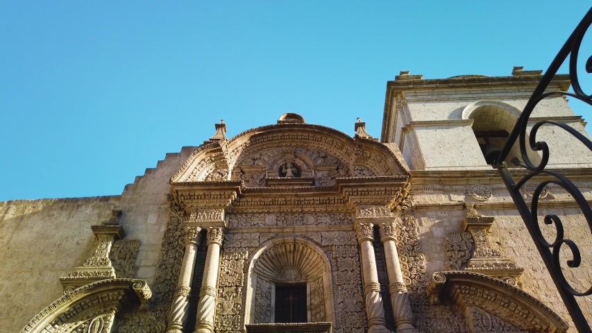 Front view to church facade. Traditional details of flowers, statutes and full decoration carved in white rock, Church of The Company, Arequipa City, Peru
