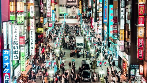 Tokyo, Japan - Nov 2, 2019: time-lapse of crowd Asian people walk on Kabukicho street, Shinjuku red-light entertainment district. Tokyo nightlife tourist attraction, Japan travel destination. Zoom out