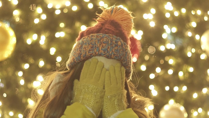 happy kid get surprised in fron of a Christmas Tree. Christmas market 