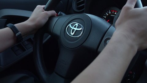 Los Angeles, CA / USA - Sept. 21, 2019: A pair of female hands guide the steering wheel of a modern Toyota during a vehicle test drive on a roadway. For editorial uses only.