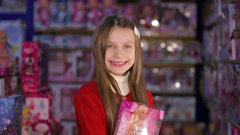 Ukraine, Ternopil December 20, 2019, Beautiful and cute girl bought the most popular doll in the world. A toy, the best gift. Good shopping