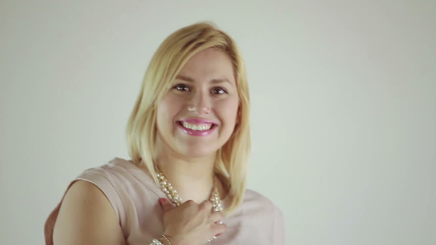 A young happy woman poses and smile over a white background.