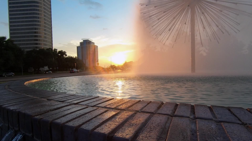 A dandelion shaped fountain in Houston Texas on Buffalo Bayou at sunset