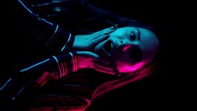 Surprised woman face in neon light. Close up of surprised girl face. Portrait of fashion model wow expression. Close up of shocked woman looking camera. Vertical video - Powered by Shutterstock - Get 15% off with code: PIKWIZARD15