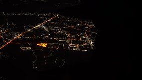 View of the airplane window over the city at night.