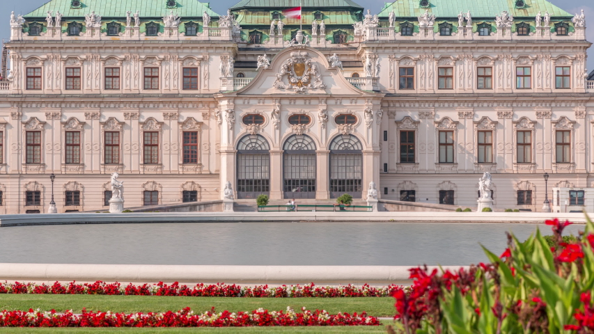 Belvedere palace with beautiful floral garden timelapse, Vienna Austria. Blue sky with clouds on sunny day. Green lawn and historic buildings