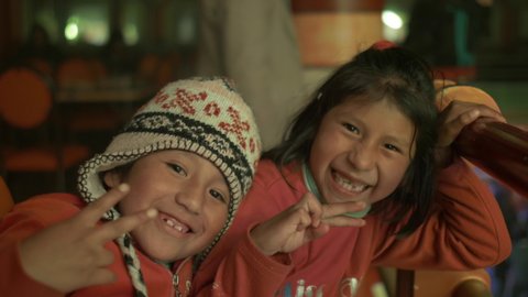 El Alto, La Paz / Bolivia - July 6 2015: Little Indigenous Girls Posing with their Hands and Smiling at the Camera at a Cholet Party