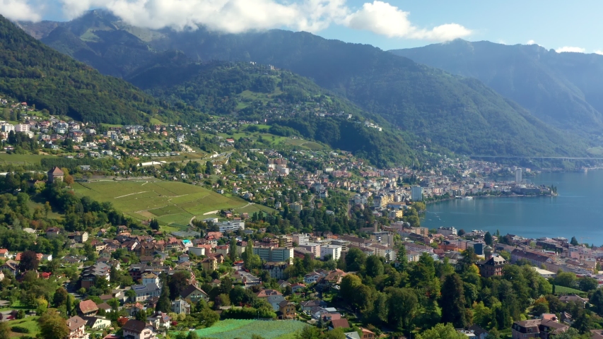 Montreux city aerial shot at Lake Geneva shoreline at Swiss Confederation with Alps Mountains
