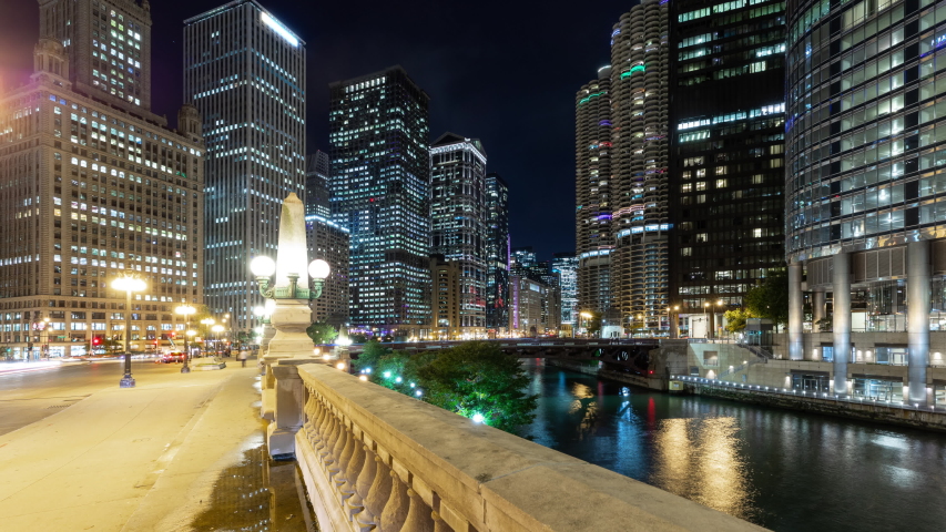 Beautiful time lapse of the many high-rise buildings along the Chicago River at night.