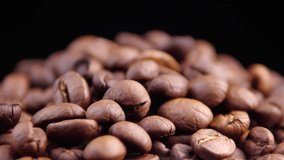 Dark Coffee Grains. Rotating and falling. Coffee beans. Footage