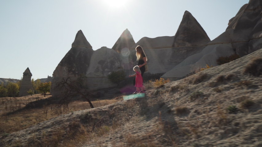Young mother walking with her daughter in cappcadocia love valley