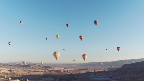 Many colorful hot air balloons flight above Goreme Valley Cappadocia at summer morning - Aerial drone view