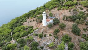 Gelidonya sea Lighthouse at  cape in Mediterranean sea. Lighthouse and three Islands on Lycian Way in Karaoz, Aerial view Drone Shooting 4K Video / Antalya Province in Turkey.
