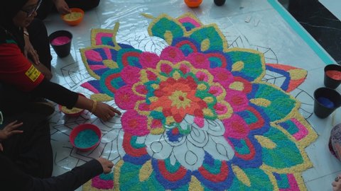 KUALA LUMPUR, MALAYSIA - DECEMBER 25TH, 2019.  Rangoli is an art form originating in the Indian subcontinent. Groups of people make Rangoli using colored sand.