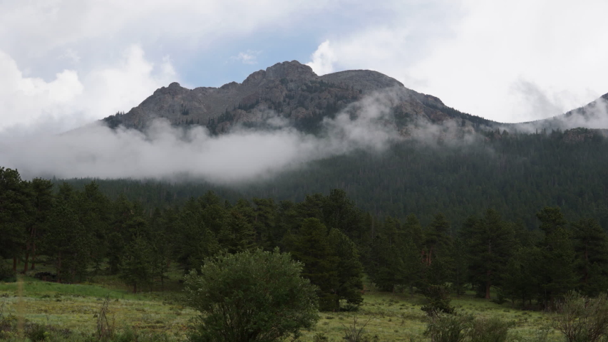 Time Lapse of Clouds Rising Above Evergreen Forest and Peak in Rocky Mountain National Park, Colorado USA