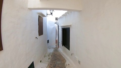 Binibeca, Menorca/ Spain- September 27, 2019: Binibeca fishing village with white houses in summer time. Wide angle view with skow motion camera movement. 