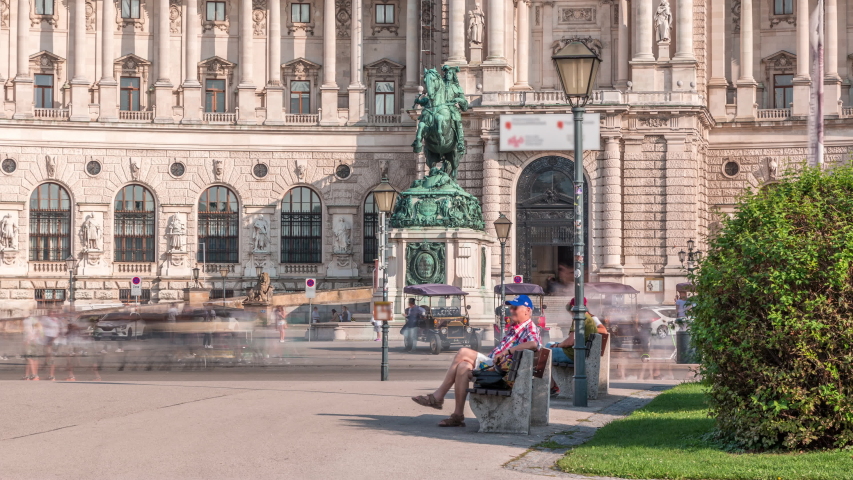 Equestrian statue of Prince Eugene of Savoy timelapse (Prinz Eugen von Savoyen) in front of Hofburg palace, Heldenplatz, Vienna, Austria. People walking around