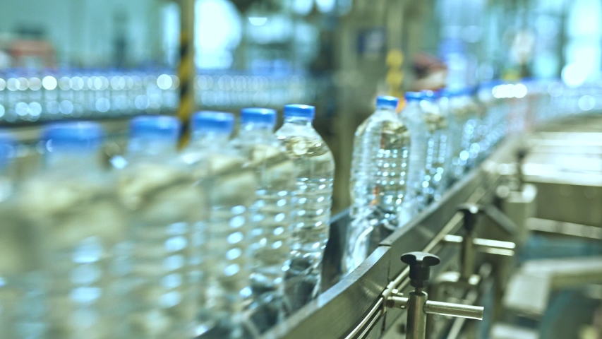 The new plastic bottles on the conveyor belt at the drinking water factory. Royalty-Free Stock Footage #1043514343
