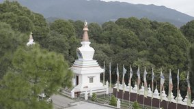 Beautiful Monastery Stupa Prayer Flags in Mountains Himalayas Green Nature filmed on Drone Aerial RAW footage for post processing
