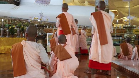 28/11/2019 pretty young teenage nuns in pink visiting Shwethalyaung reclining buddha temple in Bago (Pegu), Myanmar