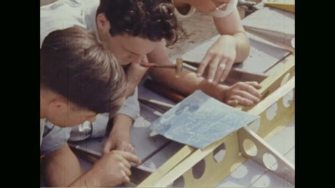 CIRCA 1940s - Teenage boys work on the construction of a sailplane at Lake Cassidy, Michigan.