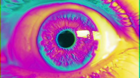 Psychedelic Eye Multicolored Glitch. Extreme close up of an wide opened eye in a psychedelic effect.