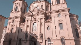 Scenic cinematic slow motion video of St Nicholas Church at Mala Strana (Kostel sv. Mikulase) - the most famous Baroque church in capital of Czech Republic Prague