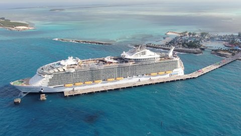 CocoCay, Bahamas - 12 15 2019: Symphony of the Seas, the biggest cruise ship in the world docked at Royal Caribbean private island Perfect Day at CocoCay seen from above