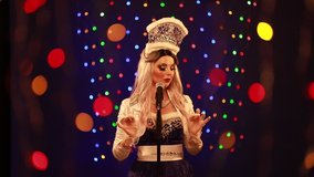 Video clip young woman singer in a New Year costume Snow Maiden sings a song in stage light