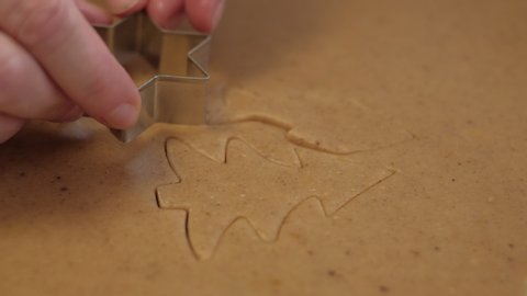 Cutting out Christmas gingerbread cookie in shape of star. 4K resolution close up shot on a gimbal. Czech Republic