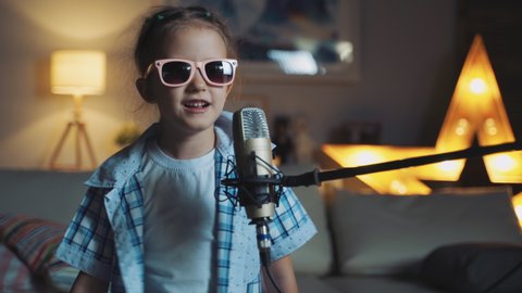 Little Girl Child Singing Song Into Microphone At Home