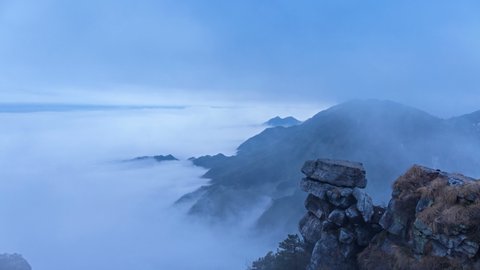 time lapse of beautiful lushan mountain landscape, cloud fog in valley with big rock , a famous tourist destination in China.