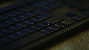 Close-up Macro Shot: Person Using Black Computer Keyboard, Pressing Enter Button. Working, Writing Emails, Using Internet. Dark and Blue Colors