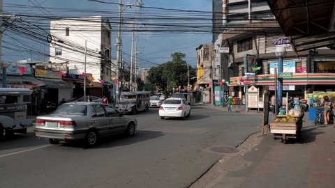 Manila, Philippines - August 26, 2019: Traffic on streets of Manila, busy cars and people going about their day in capital of Philippines