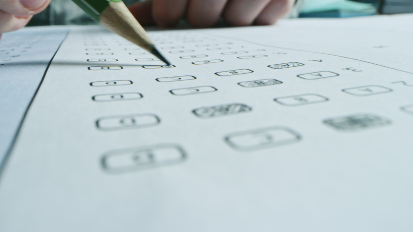 On Exam Test Person Colors Right Answers with a Pencil. Filling up Answer Sheet with Standardized Tests, Marking Correct Answer Bubbles. Macro Close-up Footage Royalty-Free Stock Footage #1043584990