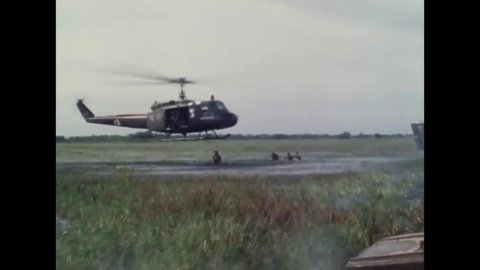 CIRCA 1966 - US Army helicopters fly over a marsh in Vietnam.