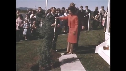 CIRCA 1960s - Antiwar protestors are shown at the Rex Hotel in Canberra and Lady Bird Johnson plants a tree in Lake Burley Griffin in Australia.