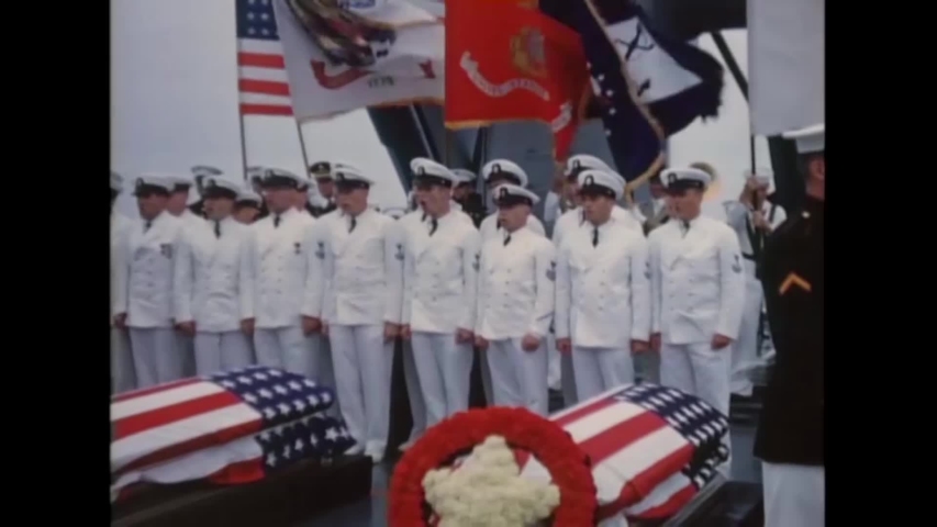 CIRCA 1958 - A Navy band and choir of CPOs participates in funeral services held on the deck of a US Navy cruiser.