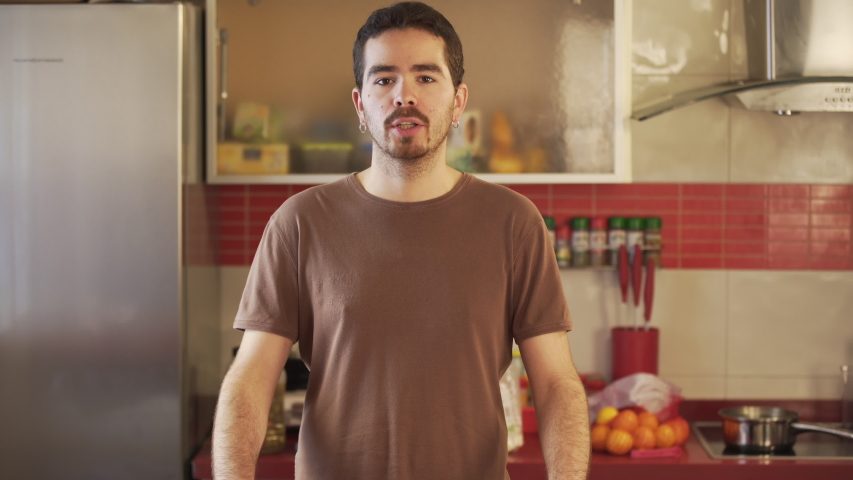 Millennial recording a video of himself in a cuisine talking to his audience