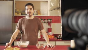 Millennial recording a video of himself in a cuisine talking to his audience