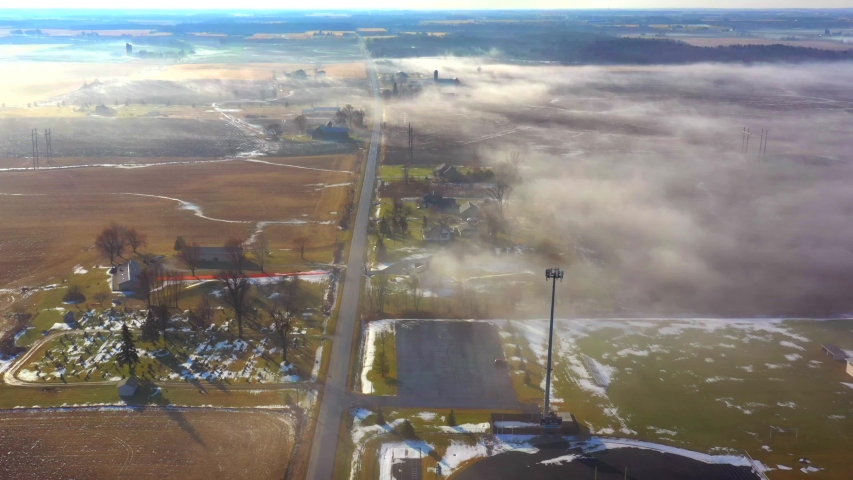 Strange steaming rural landscape. This is late December in Wisconsin when everything should be covered in snow. Proof of climate change, as the cold landscape is melted by unseasonably warm air.