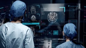 Professional doctors analyzing patient's medical MRI diagnosis by checking on a large glass screen with futuristic holograms. Concept of: medicine, doctors, future, holographic, brain scan - Powered by Shutterstock - Get 15% off with code: PIKWIZARD15