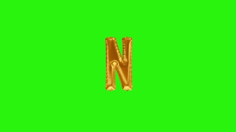 Golden letter N. Gold foil helium balloon alphabet floating on green screen