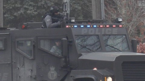 Richmond Hill, Ontario, Canada December 2019 Grainy shots of police armed tactical officers in standoff with shooting suspect