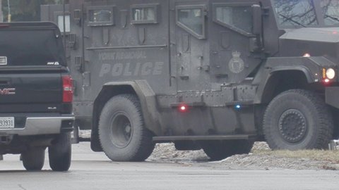 Richmond Hill, Ontario, Canada December 2019 Grainy shots of police armed tactical officers in standoff with shooting suspect