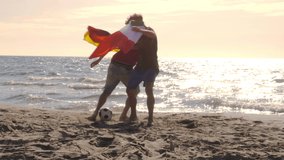 Two young men wearing italian and german flags as capes play football at the beach on the sea shore at sunset - Powered by Shutterstock - Get 15% off with code: PIKWIZARD15