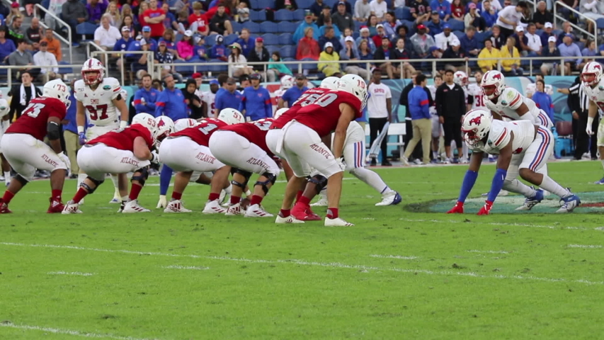 Boca Raton, Florida/USA - December 21, 2019: Florida Atlantic Owls vs SMU Mustangs. Cheribundi Boca Raton Bowl 2019. College Football players on the field in attack. Football footage with sound.